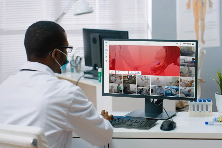 a doctor looking at his patients on his pc